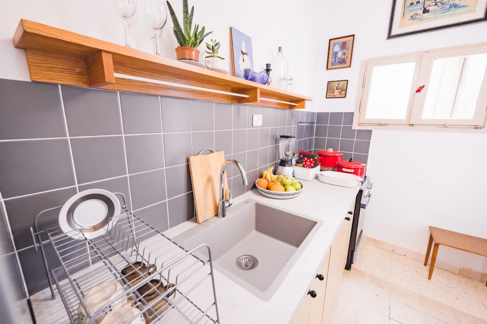 Bright kitchen counter and sink by the window in the Hadar HaCarmel apartment, Haifa